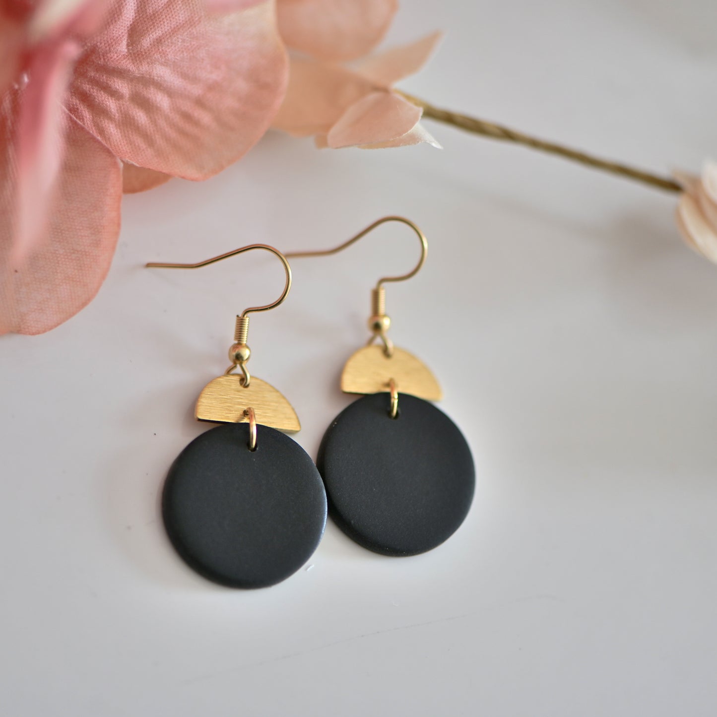 Black round polymer clay earrings, with gold charm and hooks