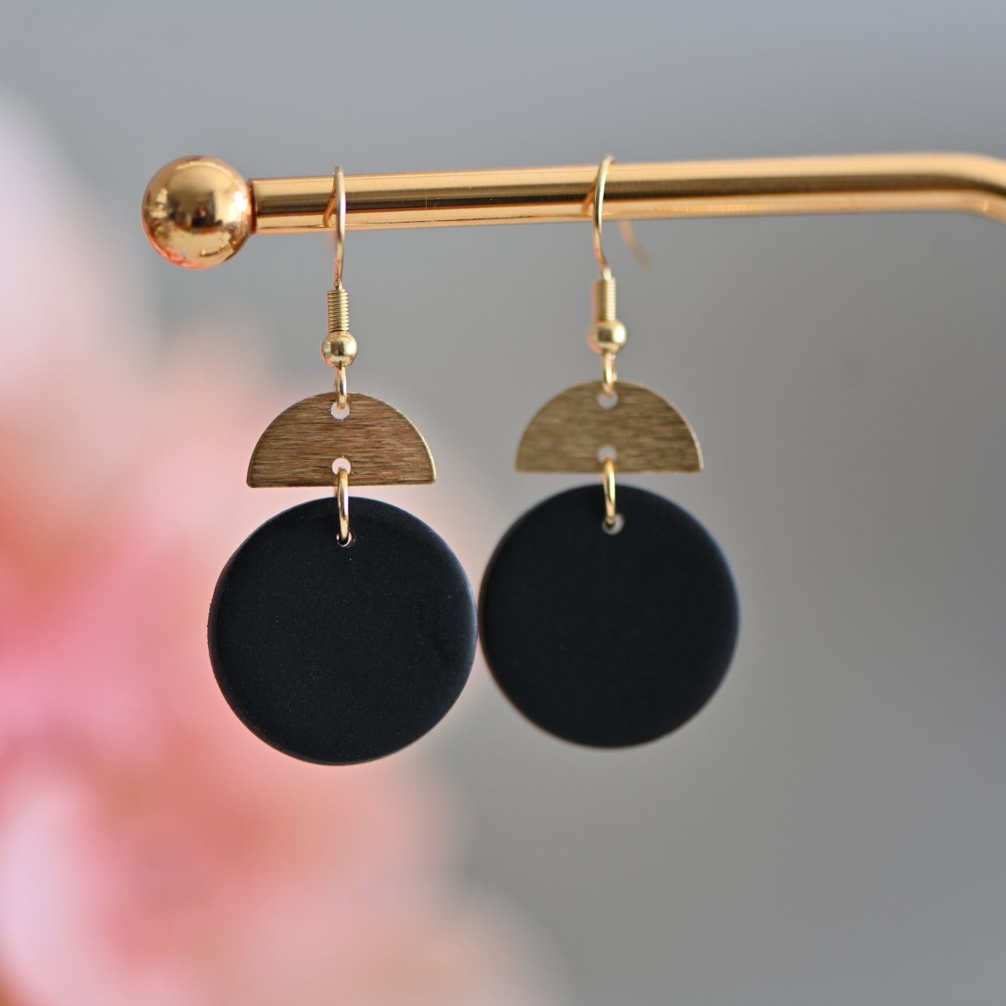 Black round polymer clay earrings, with gold charm and hooks