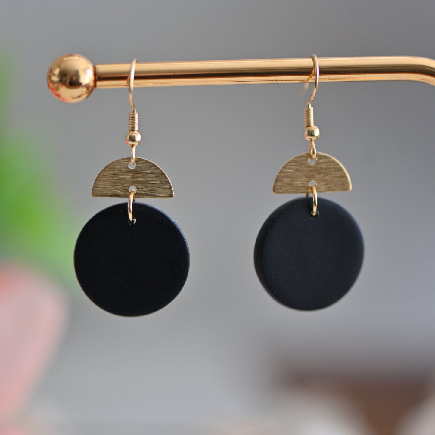 Black round polymer clay earrings, with gold charm and hooks