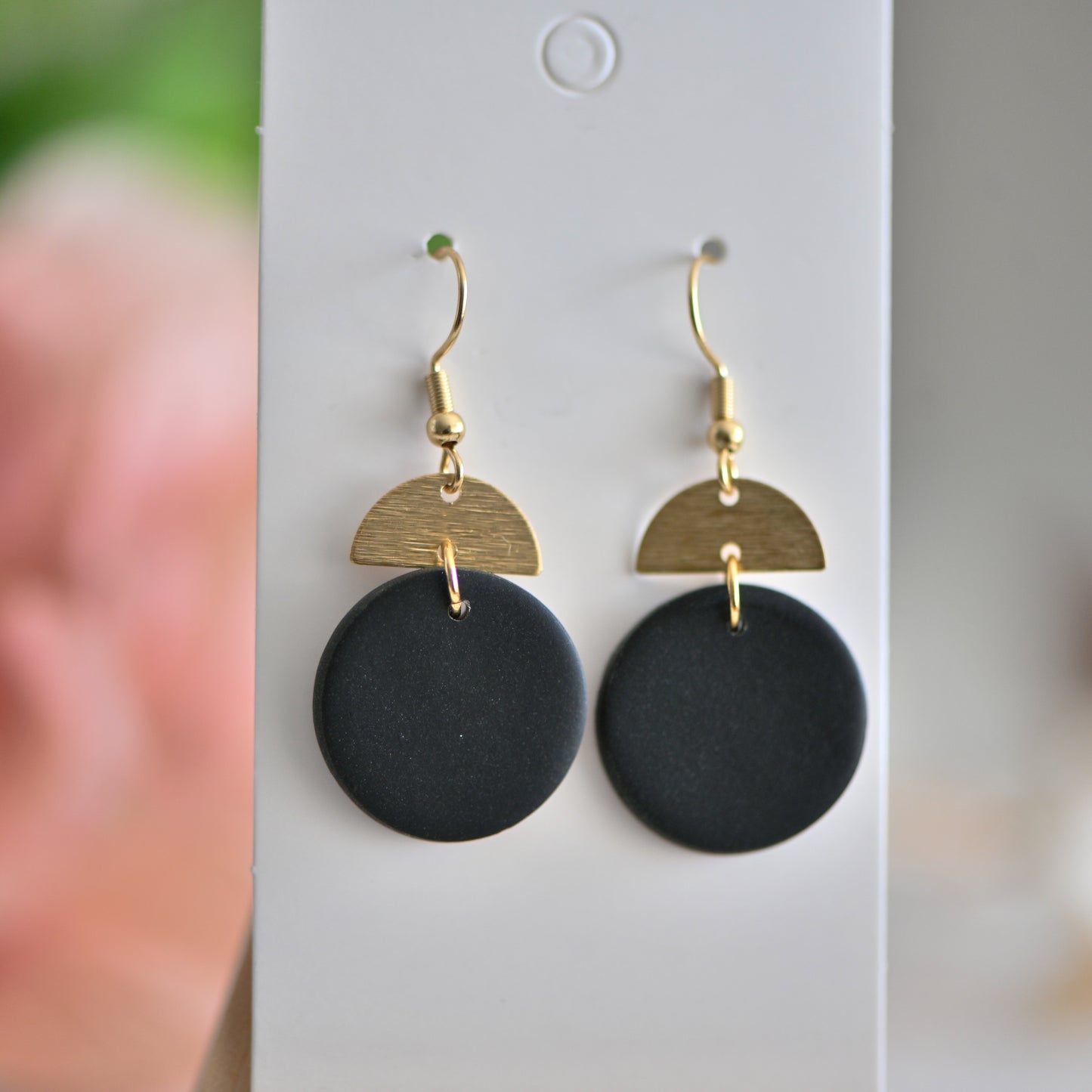 Black round polymer clay earrings, with gold charm and hooks