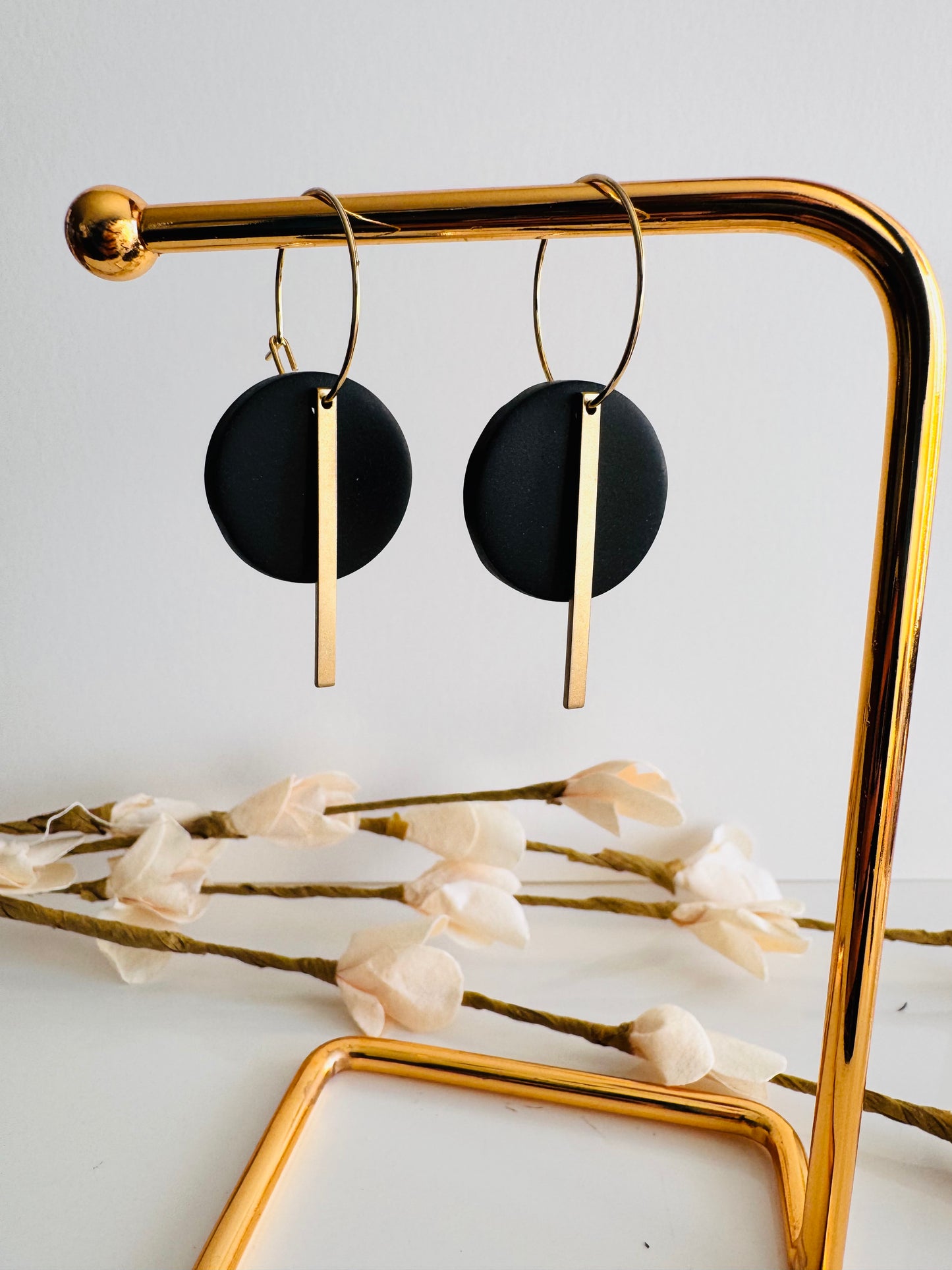 Black round polymer clay earrings, with gold charm and surgical steel hoops